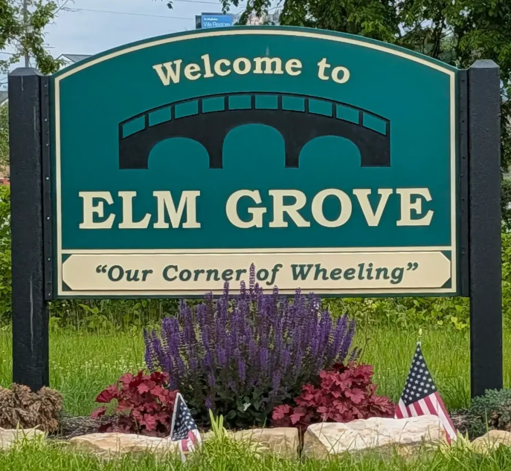 Sign at the edge of town, reading "Welcome to Elm Grove" and "Our Corner of Wheeling"