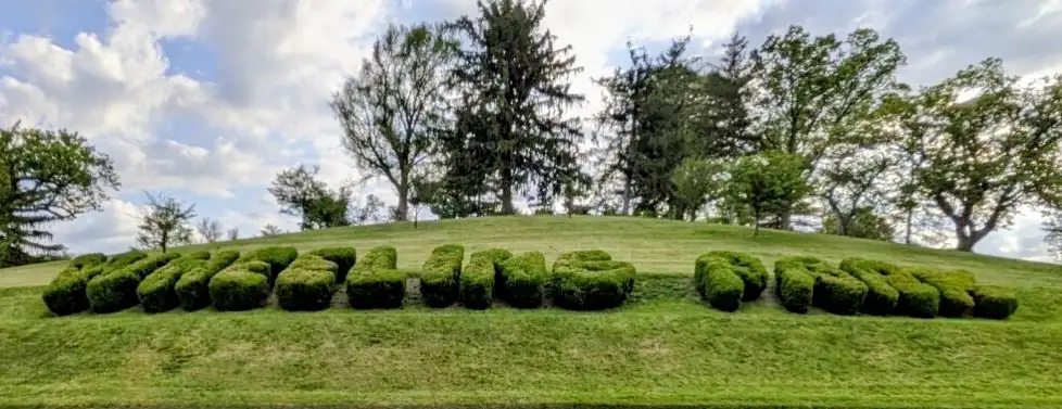Hillside at Wheeling Park. The bushes are trimmed to spell out 'Wheeling Park'